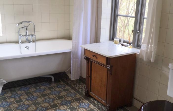 An antique Belgian ceramic in a Swedish country house bathroom