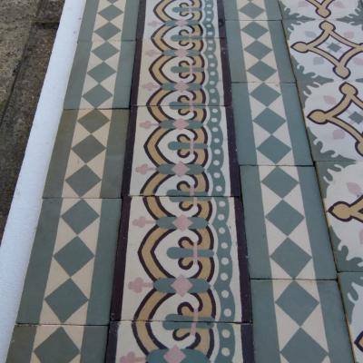 A handmade antique Belgian ceramic floor with triple borders