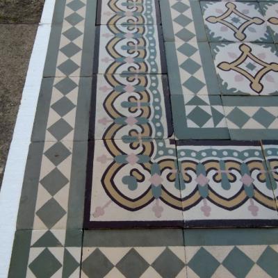 A handmade antique Belgian ceramic floor with triple borders