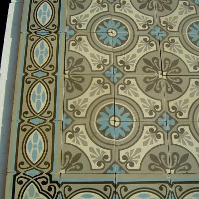 A 32m2+ / 350 sq ft antique ceramic floor in mid grey, blue and cream