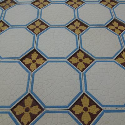 A handmade Boch Freres floor of octagon tiles with cabochons