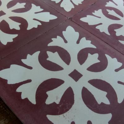 Four antique Carreaux de ciments tiles in bordeaux and white