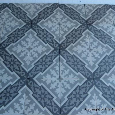 A panel of antique French ceramic encaustic tiles