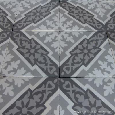 A panel of antique French ceramic encaustic tiles